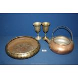 A large brass decorated bowl, copper kettle and two goblets.