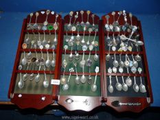 Three display racks of souvenir teaspoons.