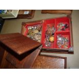 A wooden jewellery box and contents of brooches, necklaces etc.