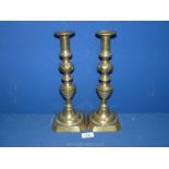 A pair of Candlesticks with pushers.