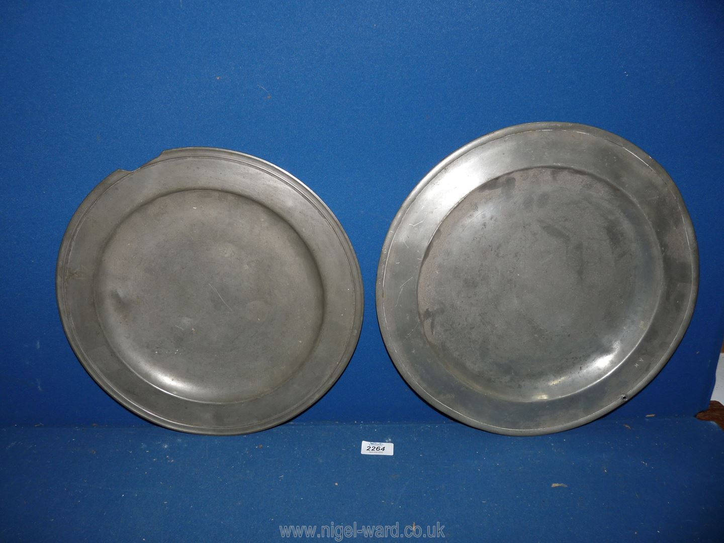 Two antique pewter chargers, one 14" and one 15" diameter, each requiring some repair to edges.