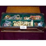 A long wooden box and contents of bracelets, clip on earrings etc.