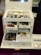 A jewellery box full of costume jewellery.