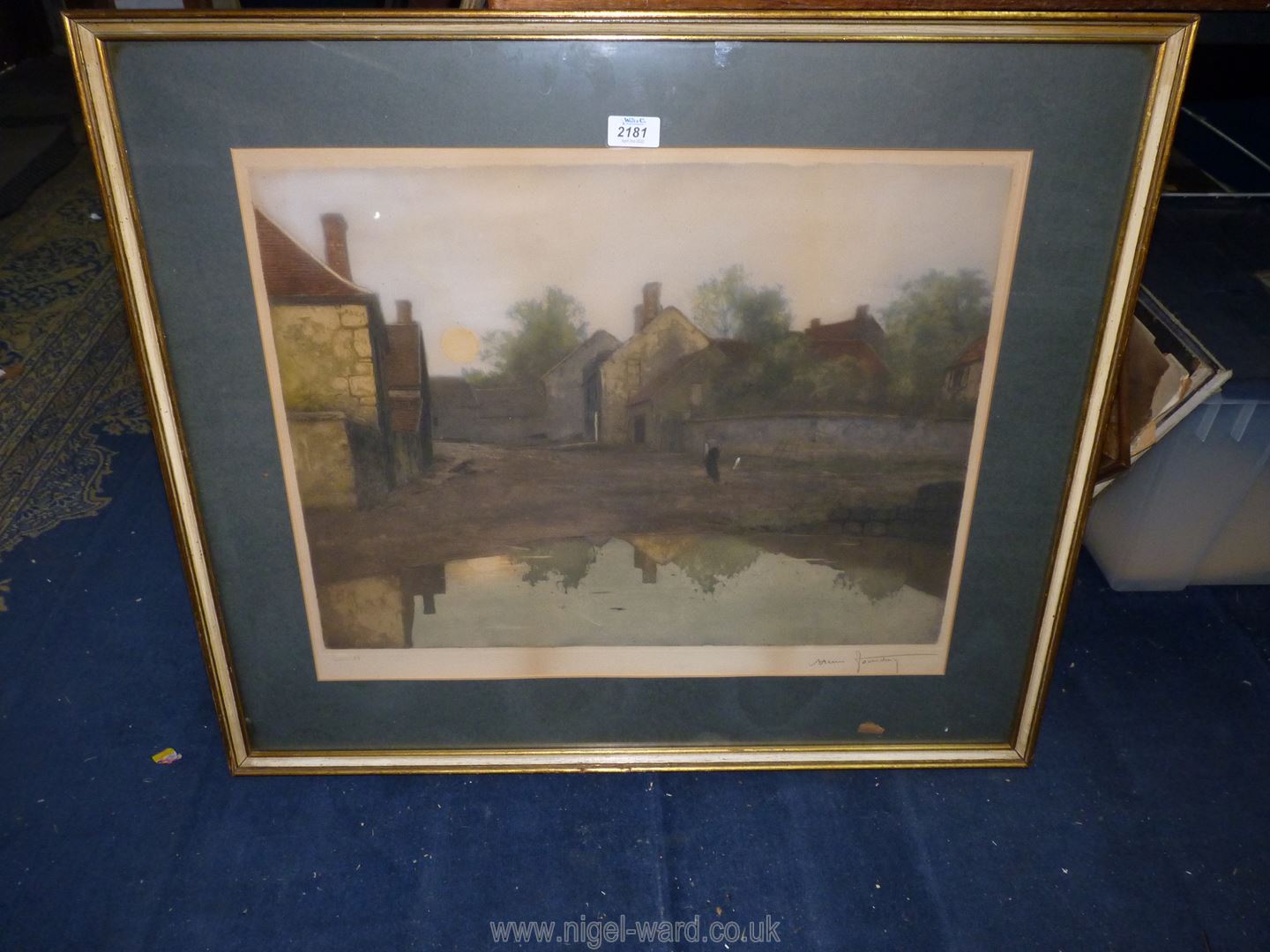 A framed and mounted lithograph of a gentleman walking through a farmyard at dusk,
