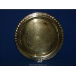 A solid brass, polished circular tray decorated with oriental figures etc.