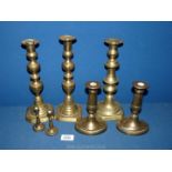 A quantity of brass candlesticks including a pair of miniatures.