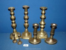 A quantity of brass candlesticks including a pair of miniatures.