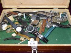 A double storage box and contents including a good quantity of pocket watch parts and wristwatches.