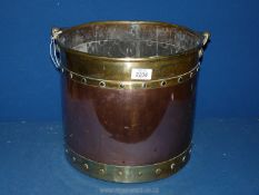 A copper and brass log basket, 12 1/2" diameter x 11" tall.