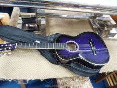 An Ashton acoustic guitar in purple colour with soft case.