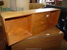 A pine table top storage rack with three central drawers, 35 1/2" W.