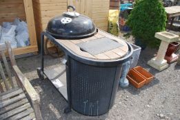 A charcoal BBQ Kettle on stand incorporating chopping board and bin, 31 1/2 " tall x 45" long.