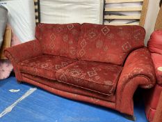 A two seater sofa with large foot stool.
