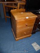 A pine bedside chest of drawers, 17" W x 24" H.