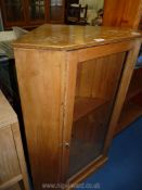A Lightwood corner cabinet, with glazed doors, 29" W x 42 1/2" H.