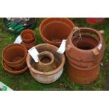 A clay chimney pot (damaged) and assorted terracotta pots a/f.