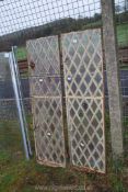 A pair of cast iron diamond panel windows, (bottom opening), 55" high.