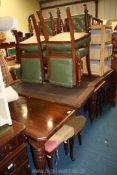 An Edwardian extending dining Table with two spare leaves,