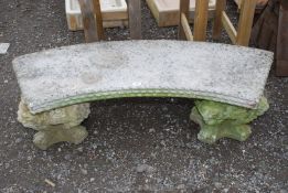 A curved concrete bench with lion plinths