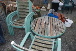 A round metal framed table with wood slats,