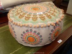 A Moroccan style pouffee, all fabric, 18" diameter x 8 1/2" high.