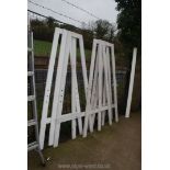 Five large wooden A-frame stands with peg holes.