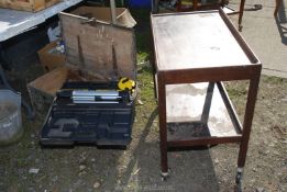 An old wooden tool box with tools, fishing reel etc.