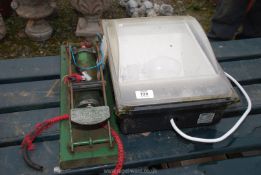 An Aerite foot pump and large outdoor floodlight.