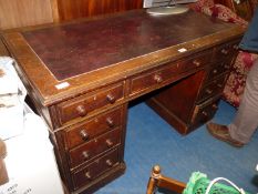 A dark-wood kneehole writing desk with brown leather insert, a/f, 46 1/2" W.