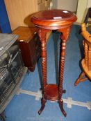 A mahogany plant stand with barley twist legs,