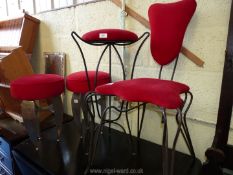 A pair of stools, chair and bar stool with metal frames and red velour upholstery.
