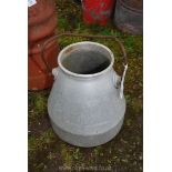 An aluminium milk/dump bucket.