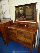 A dark-wood dressing table with swing mirror up-stand.