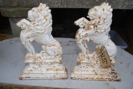 A pair of cast iron rearing lions doorstops, 15'' high.