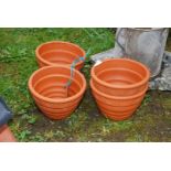 Four ribbed terracotta pots.