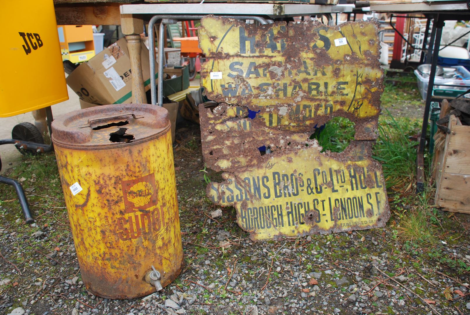 An old Shell Oil can with tap dispenser and a Halls metal advertising sign a/f.