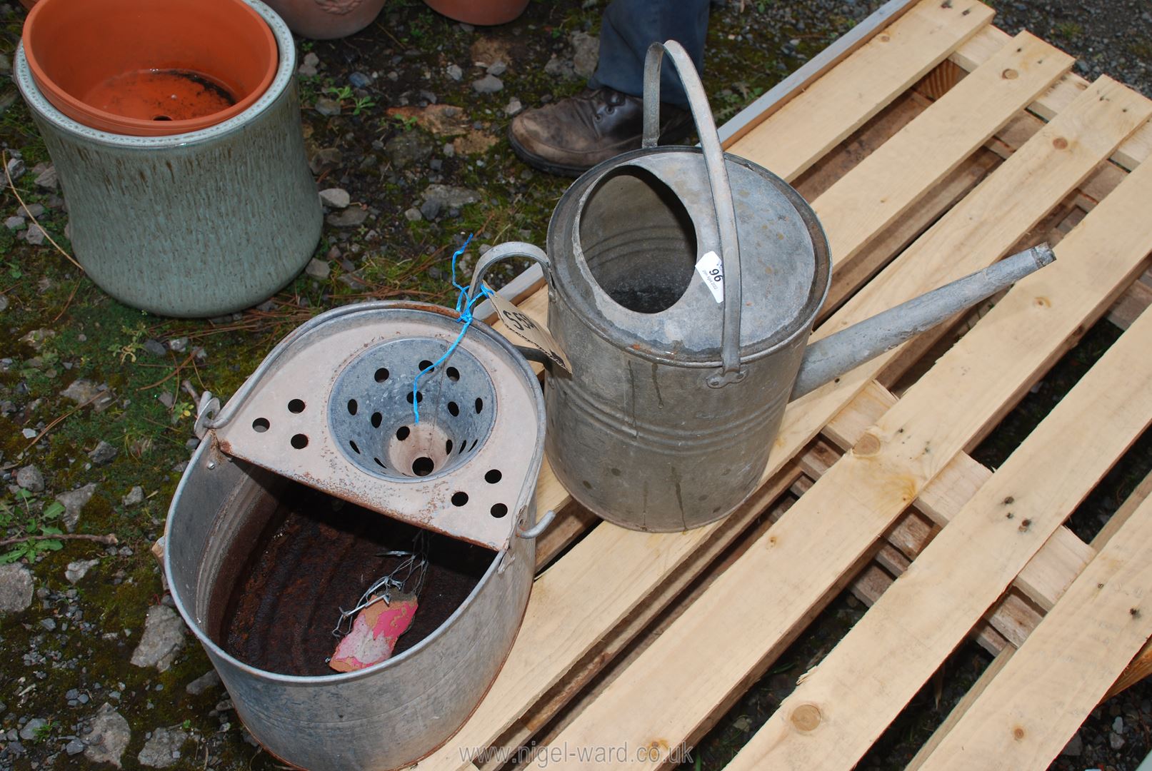 A galvanised mop pail and vintage watering can