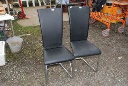 Two leatherette and chrome dining chairs