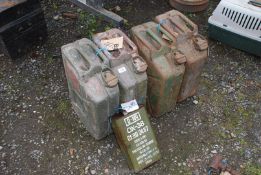 Four green metal Jerry cans and a five litre can.