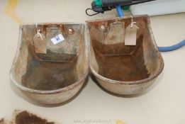 A pair of cattle water bowls.