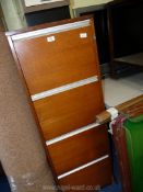 A four drawer wooden filing cabinet, 54" H x 18 3/4" W x 25 3/4" D.