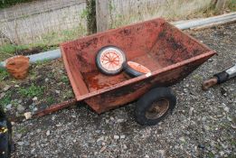 A small garden Tipper Trailer suitable for lawn tractor, having two solid 12" wheels,