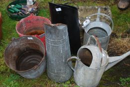 Two metal coal hods, two metal pails and two galvanised watering cans.