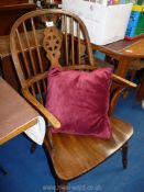 A wheelback Grandfather chair with red cushion