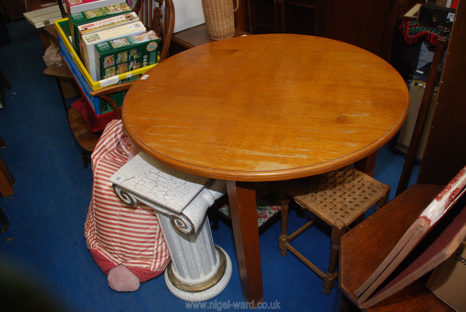 A light wood circular dining table, 39 1/2" W.