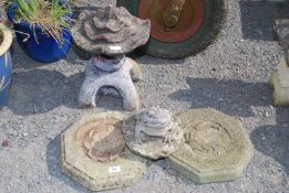 A pagoda, two stepping stones, and a frog ornament.