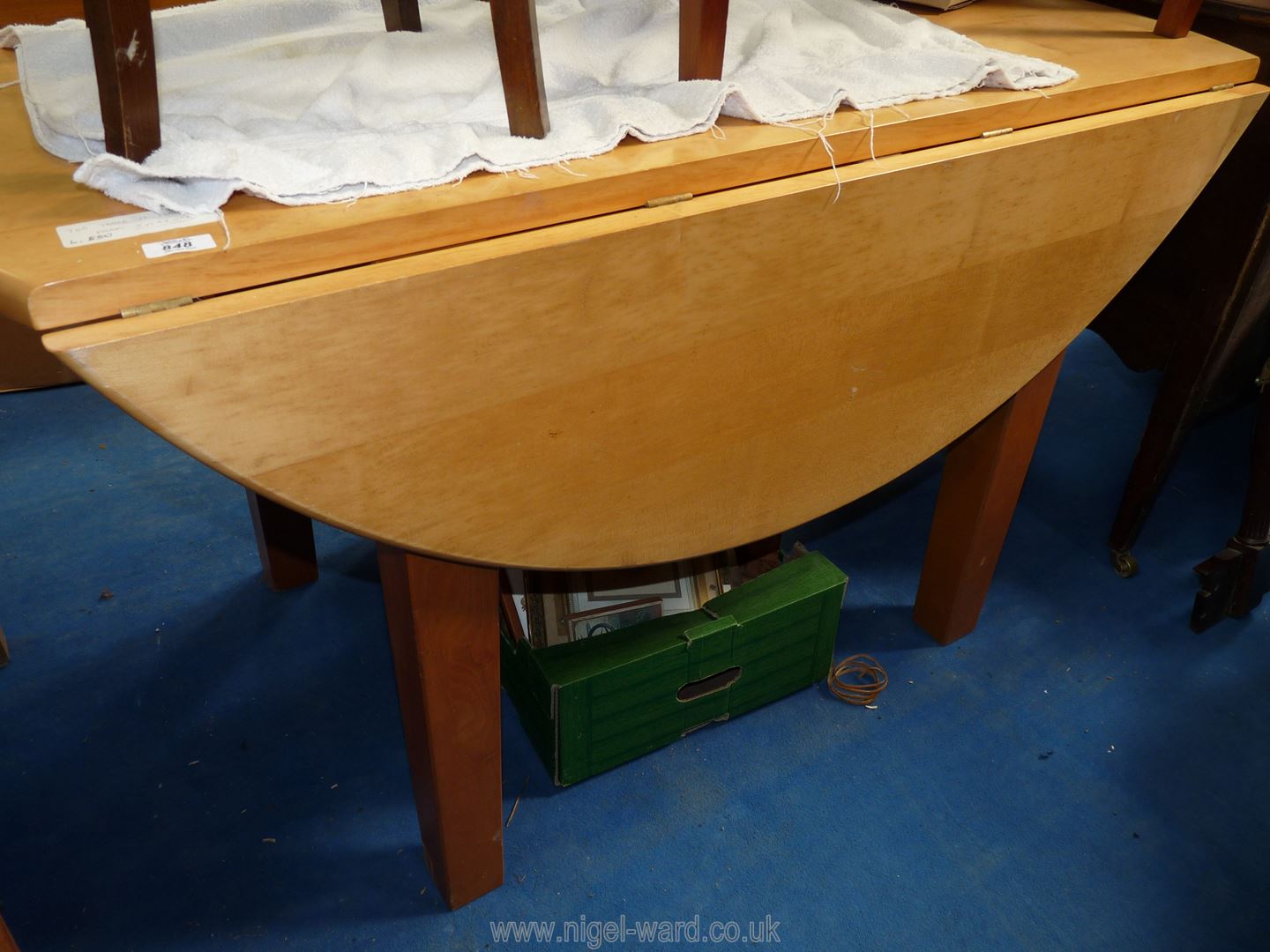 A sycamore wood drop leaf table, 52'' diameter.