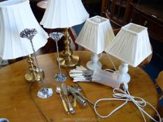 Quantity of table lamps including a pair of cream candle stands and cutlery.