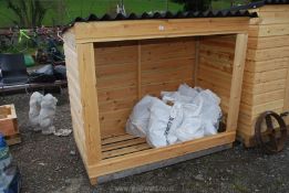 A wooden log store 62'' x 58'' x 32''.