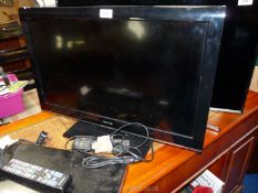 A Toshiba flat screen TV/DVD player, with remote, 26'' screen.